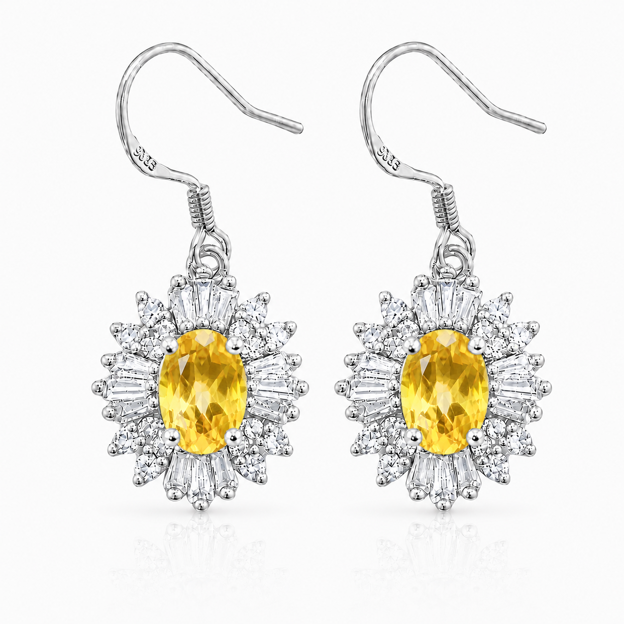 Natural 4x6mm oval citrine halo drop earrings crafted in 925 sterling silver on a pure white background.