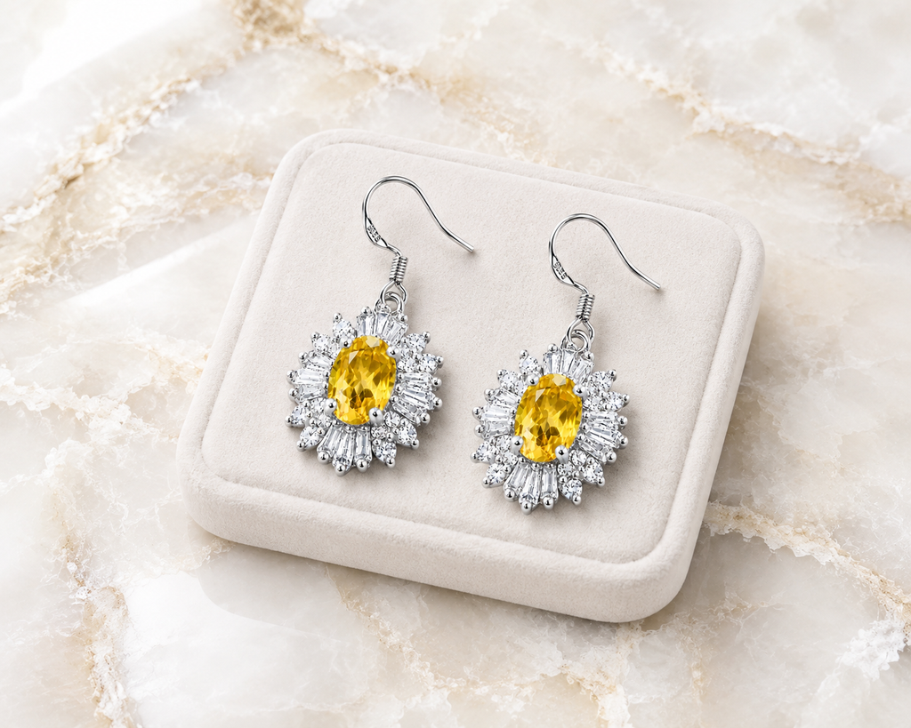 Natural 4x6mm oval citrine halo drop earrings crafted in 925 sterling silver on a pure white background.