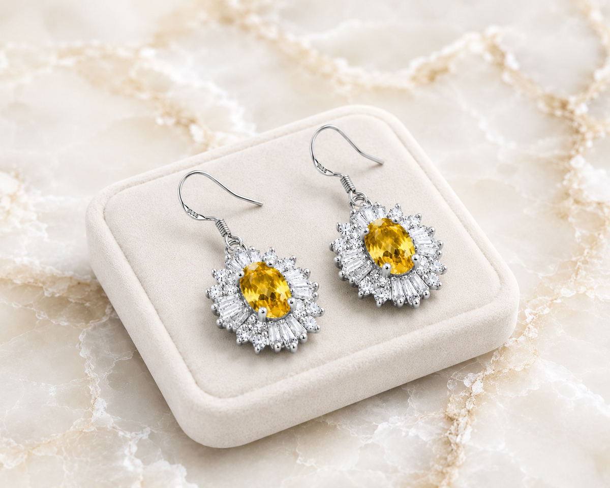 Natural 4x6mm oval citrine halo drop earrings crafted in 925 sterling silver on a pure white background.