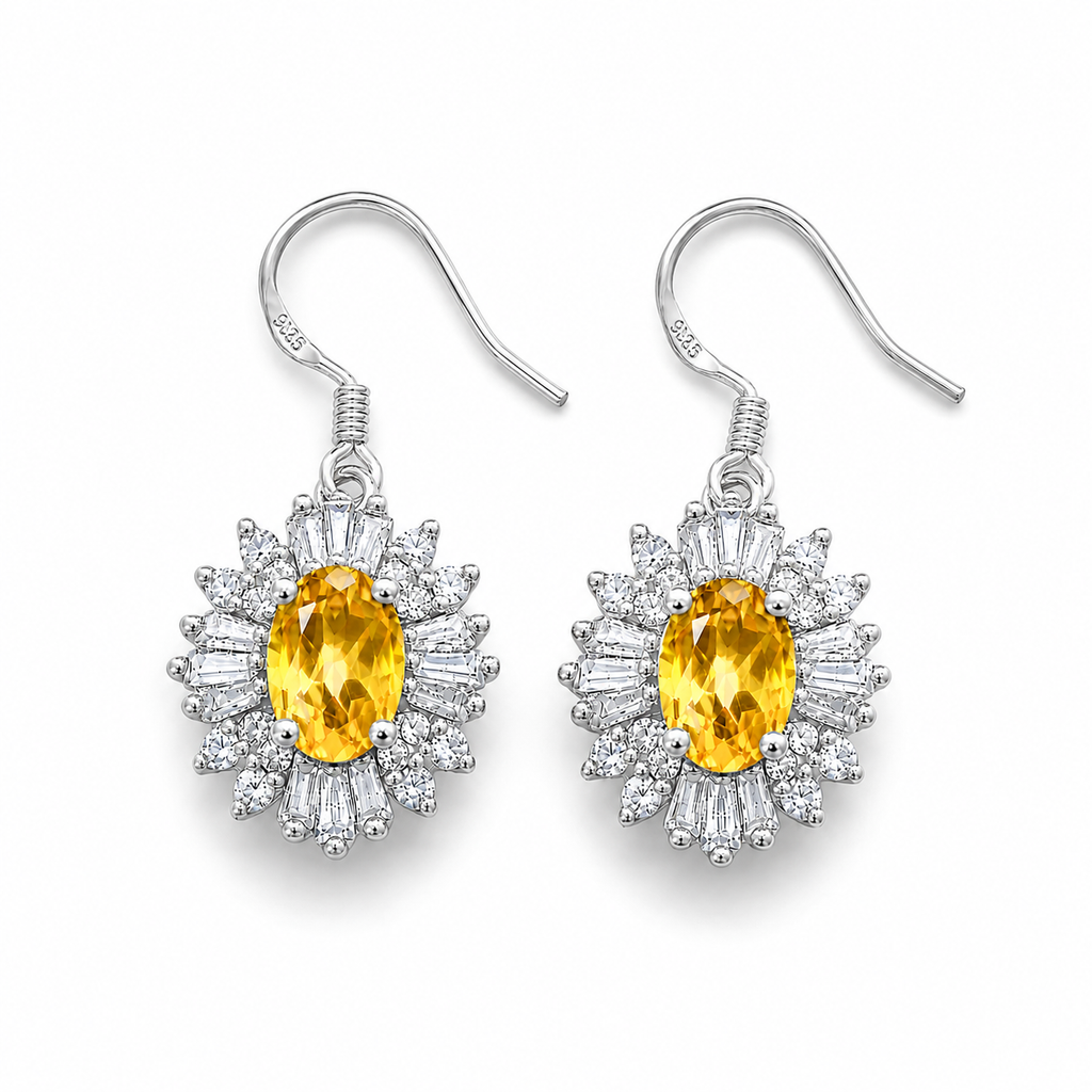Top-down view of natural citrine drop earrings with oval golden-yellow gemstones surrounded by sparkling cubic zirconia.