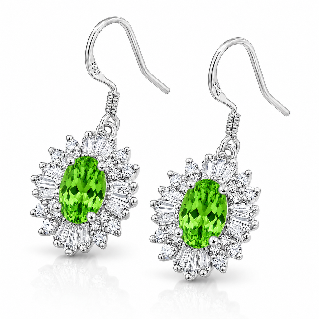 45-degree view of natural tsavorite halo drop earrings featuring vivid green oval gemstones in polished sterling silver.