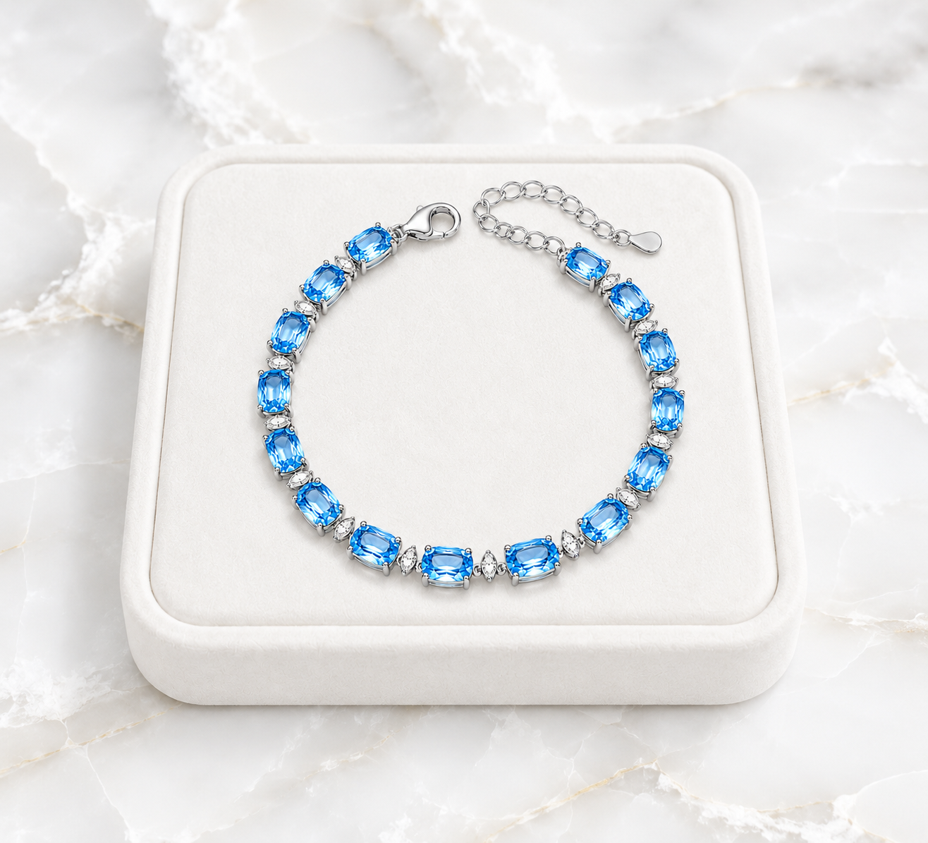 Swiss Blue Topaz bracelet displayed on an ivory jewelry tray over white marble