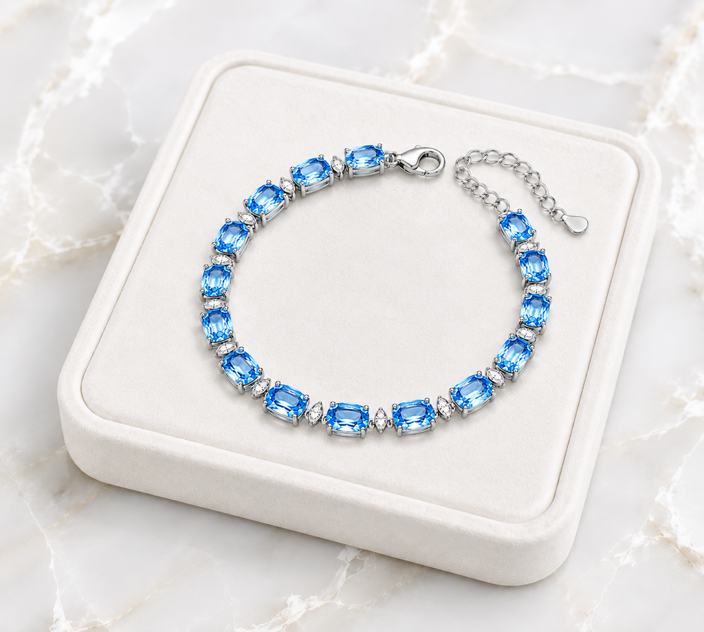 Swiss Blue Topaz bracelet displayed on an ivory jewelry tray over white marble