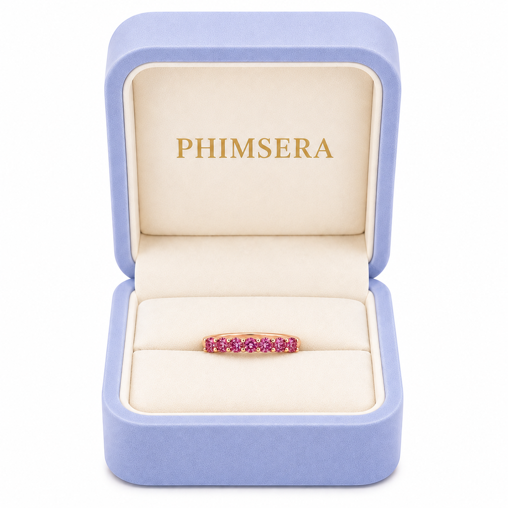 Natural Pink Garnet half eternity ring featuring seven genuine 3mm round pink garnets in rose gold plated 925 sterling silver on a white background in Phimsera box.