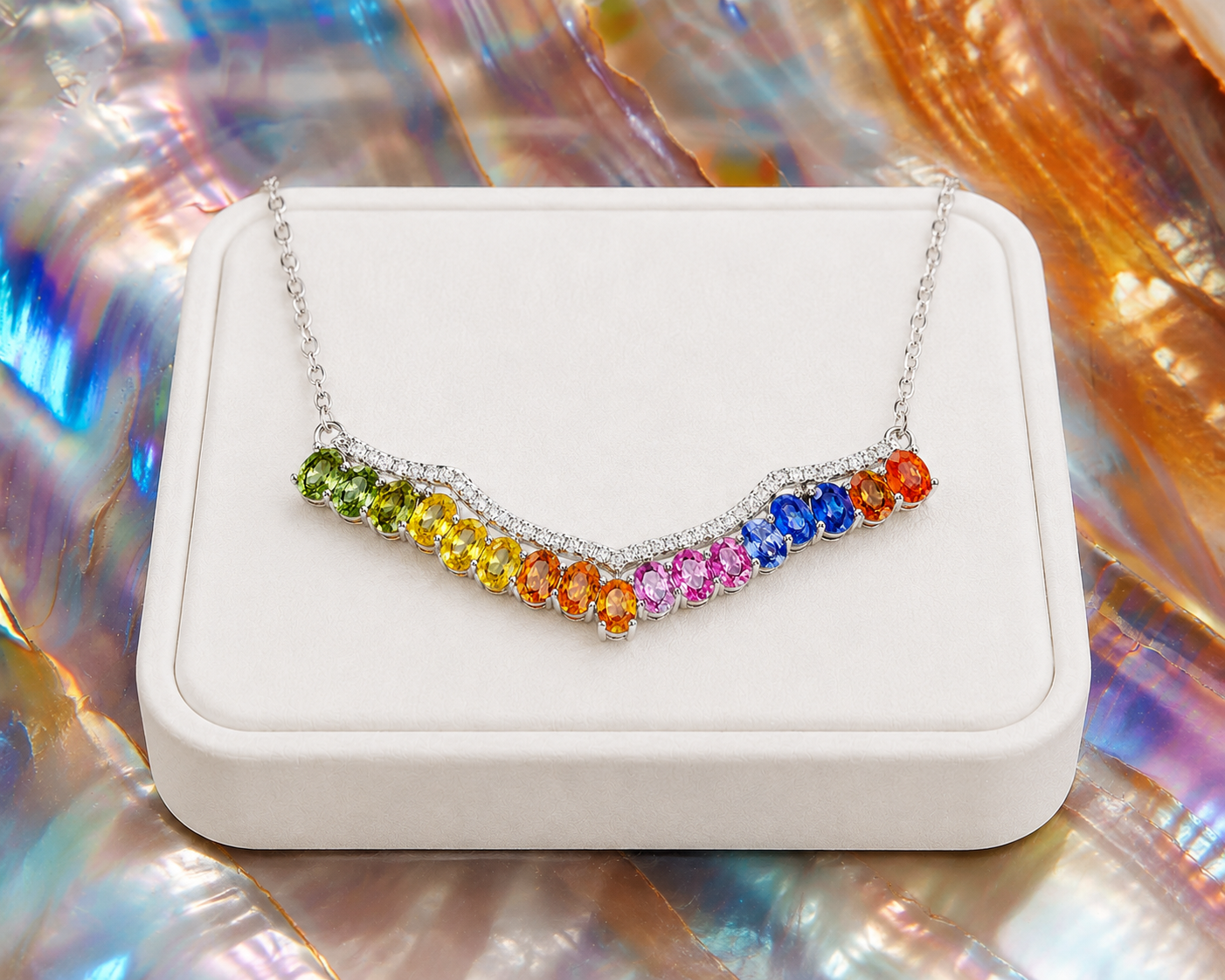 Multicolor sapphire necklace displayed on a luxury white jewelry tray with vibrant natural rainbow gemstones.