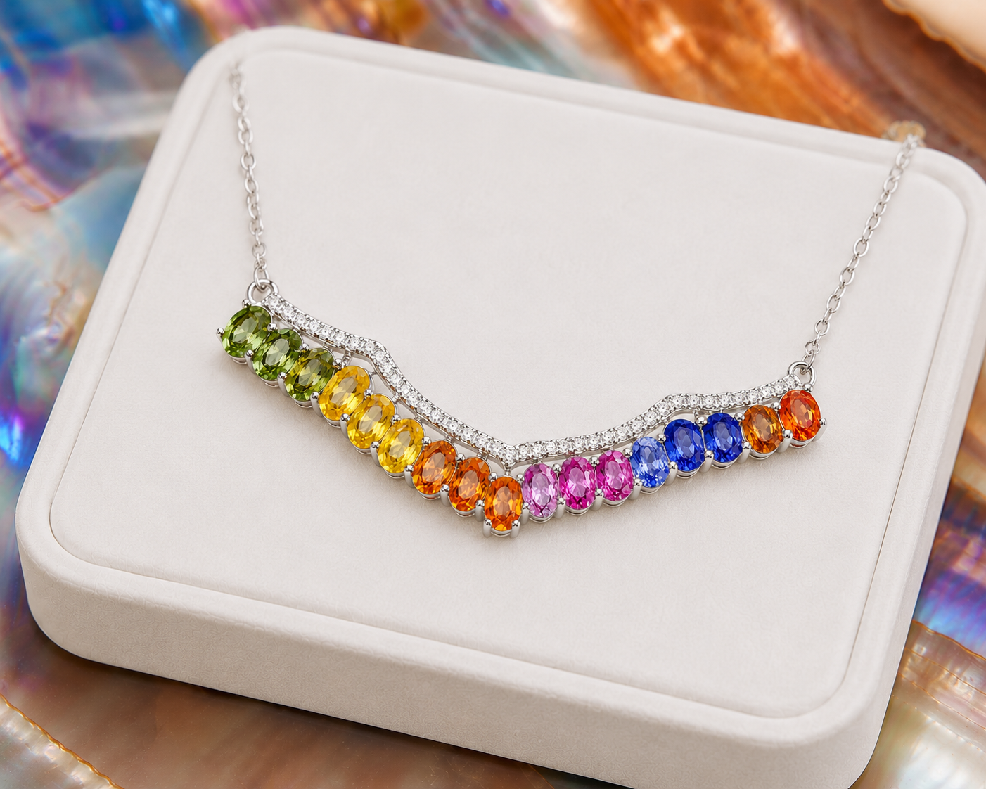 Multicolor sapphire necklace displayed on a luxury white jewelry tray with vibrant natural rainbow gemstones.