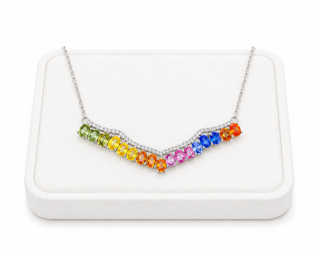 Multicolor sapphire necklace displayed on a luxury white jewelry tray with vibrant natural rainbow gemstones.