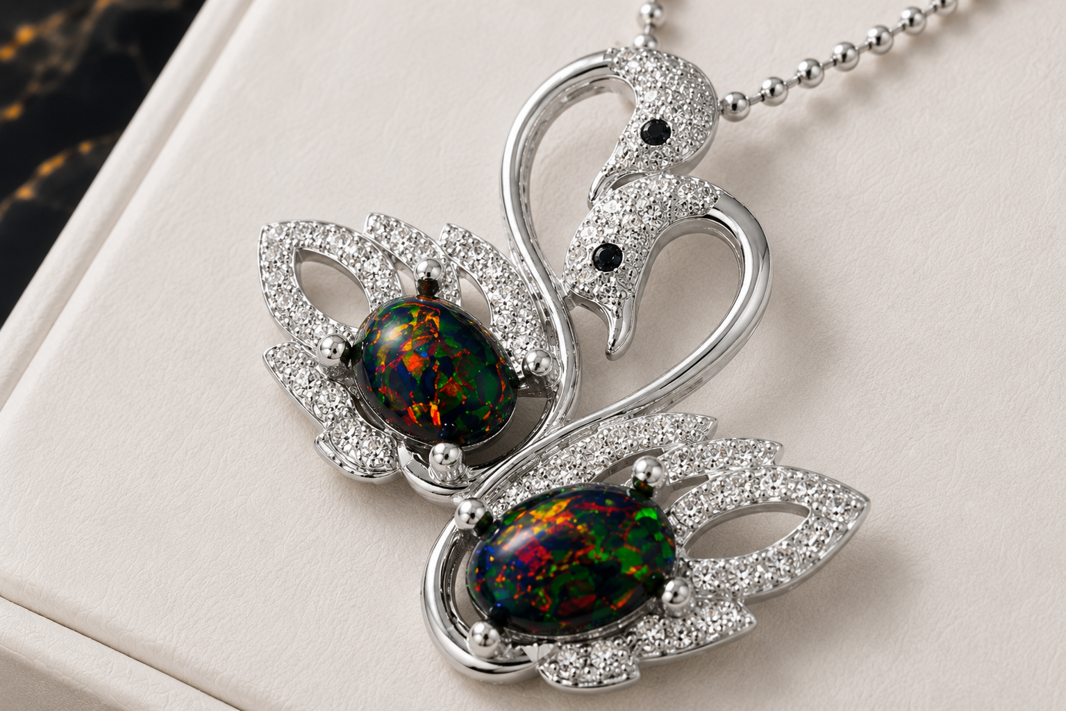Colorful black fire opal double swan necklace with two 5x7mm oval Australian opals in sterling silver