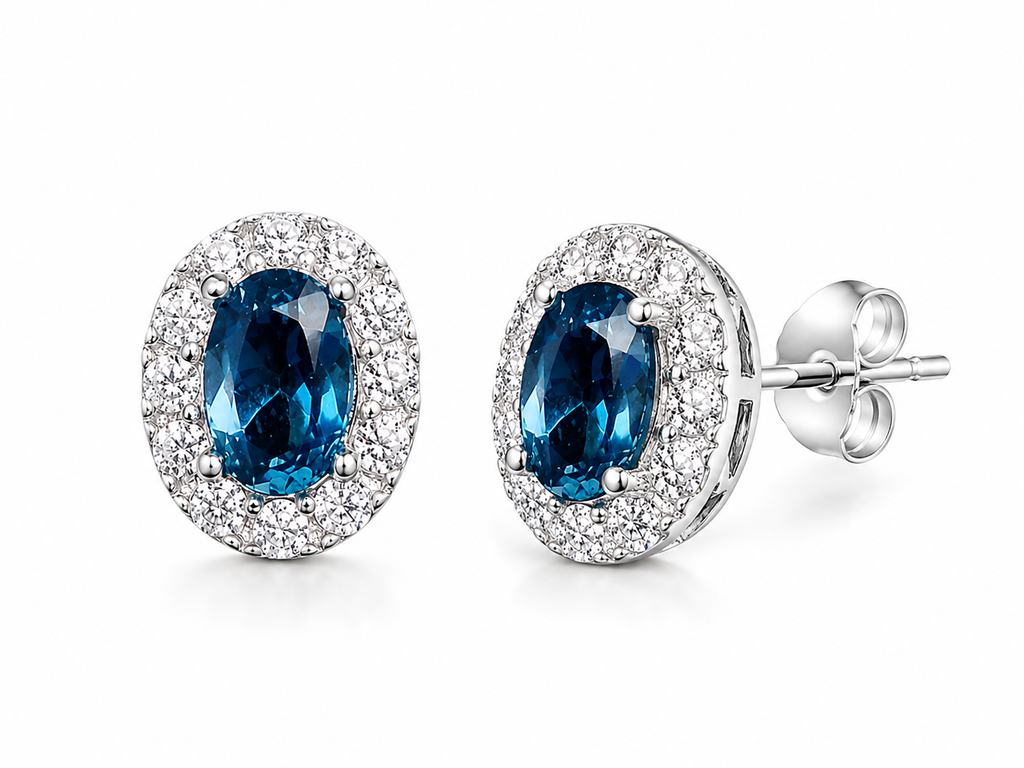 4x6mm London Blue Topaz earrings shown at 45 degree angle in sterling silver halo settings