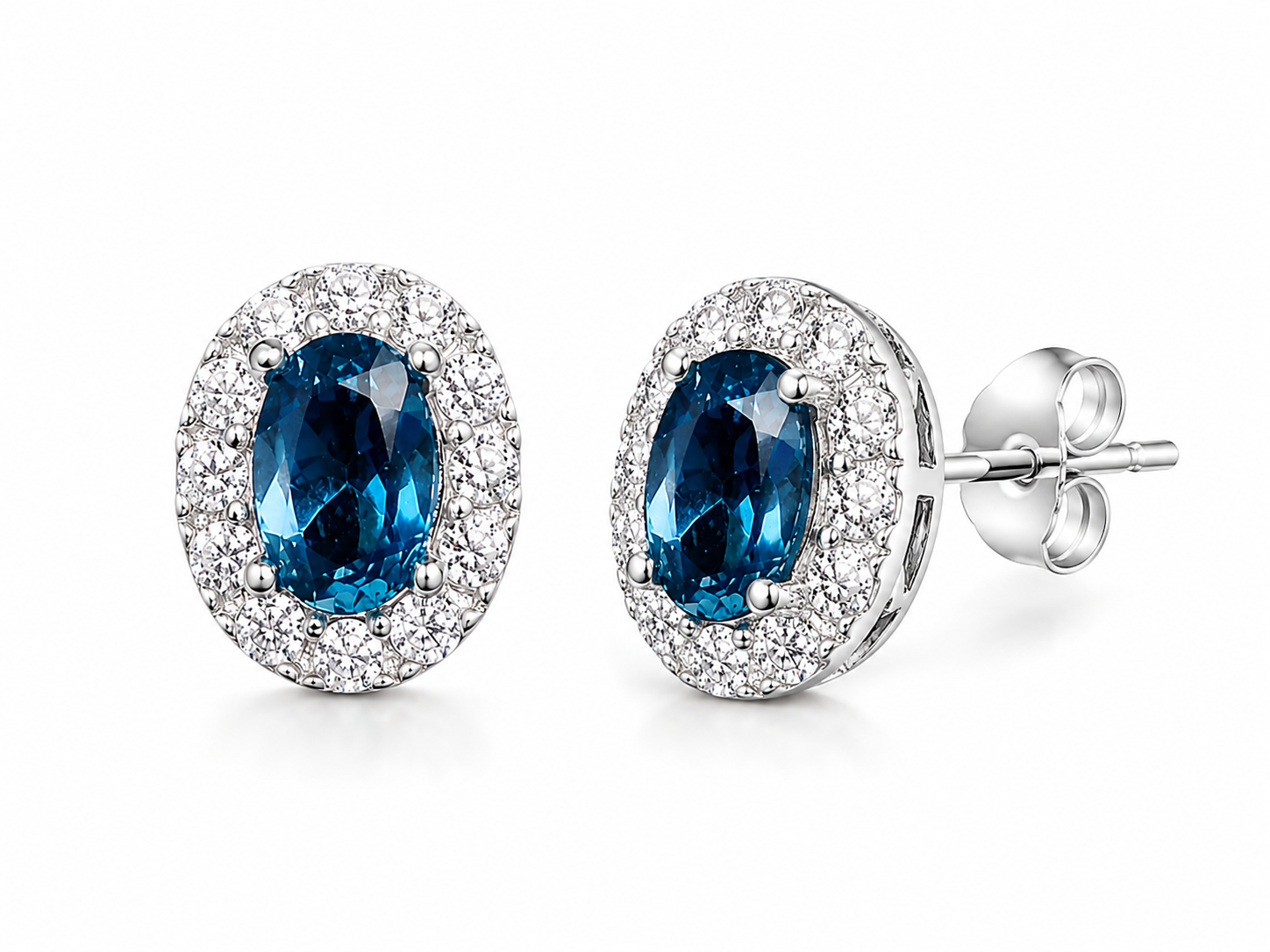 4x6mm London Blue Topaz earrings shown at 45 degree angle in sterling silver halo settings
