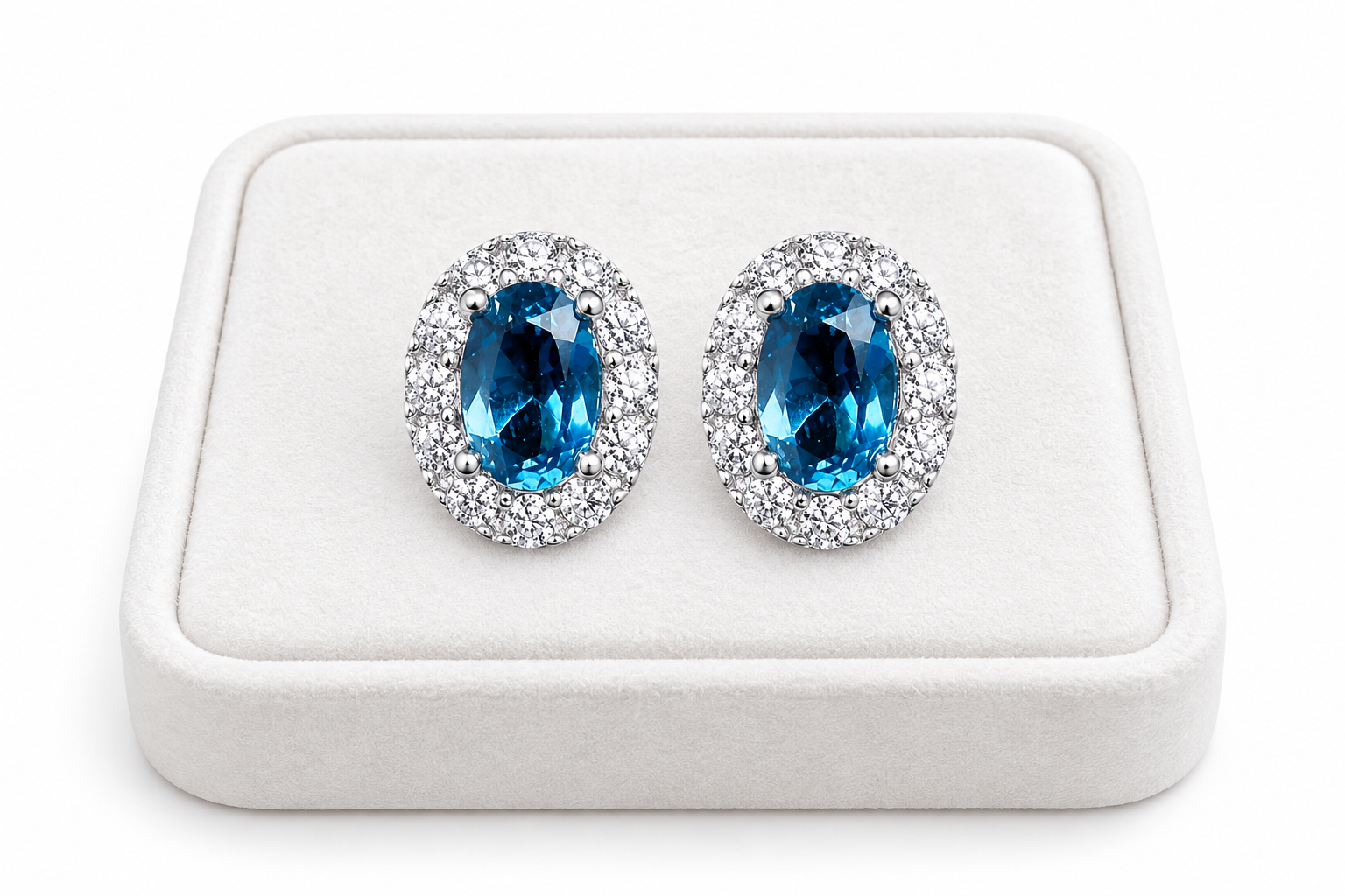 London Blue Topaz 4x6mm stud earrings displayed on a white luxury jewelry tray