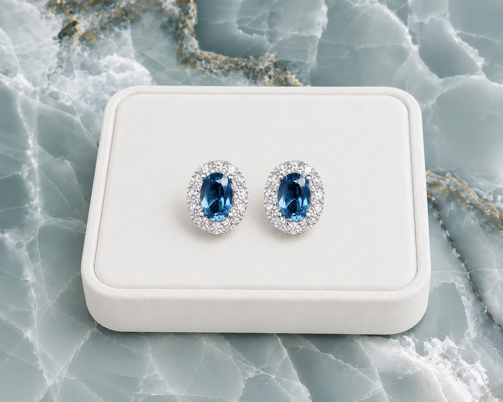London Blue Topaz stud earrings displayed on a white jewelry tray over blue marble