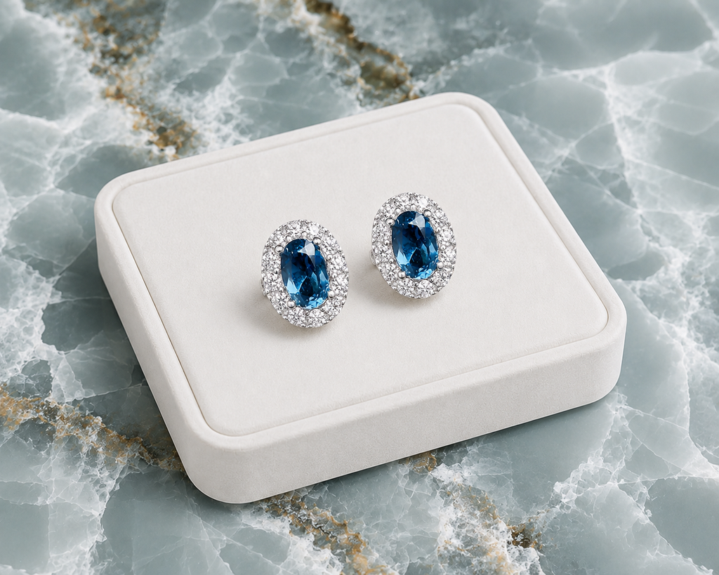 London Blue Topaz stud earrings displayed on a white jewelry tray over blue marble