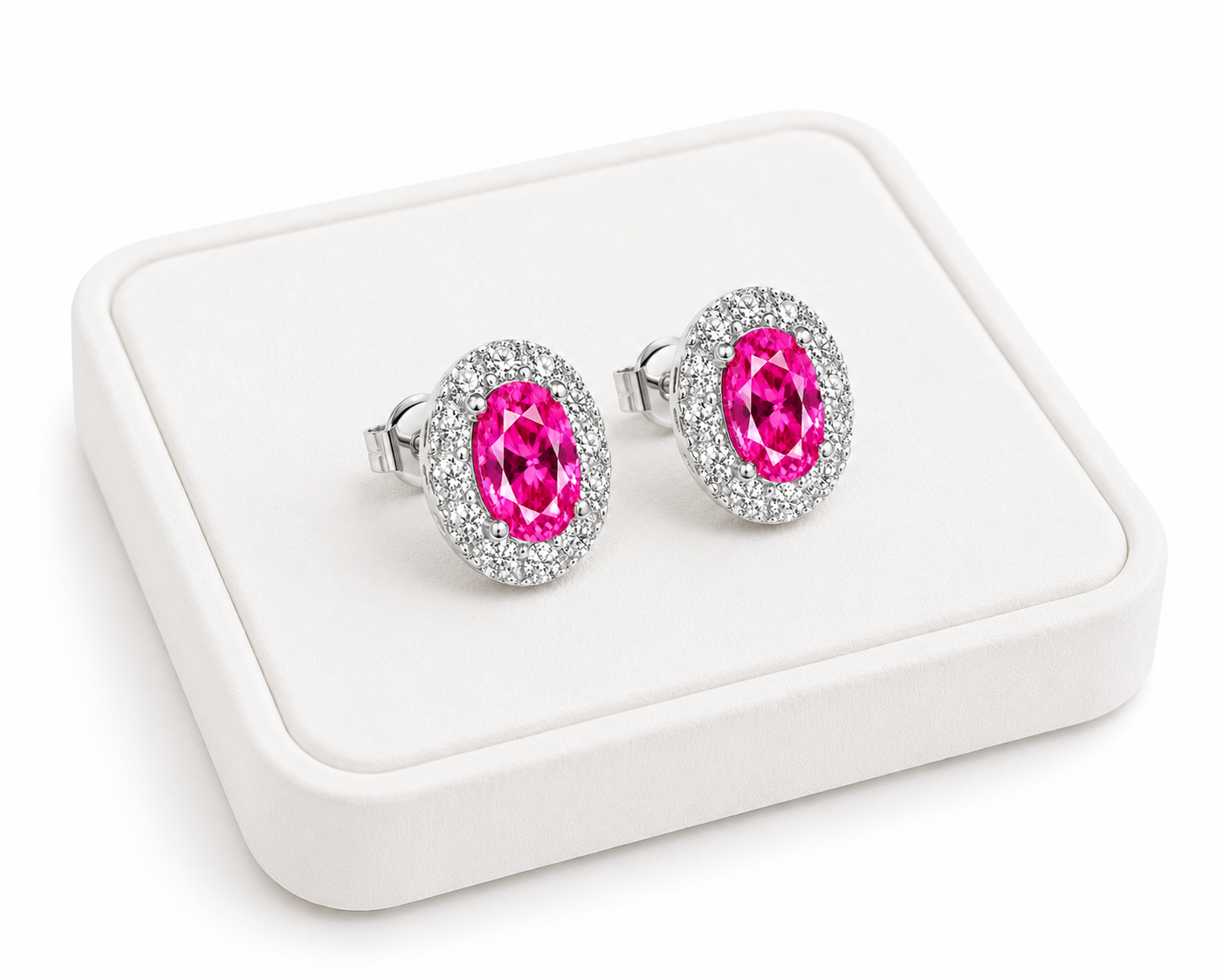 Pink topaz halo stud earrings displayed on a white jewelry tray with white background