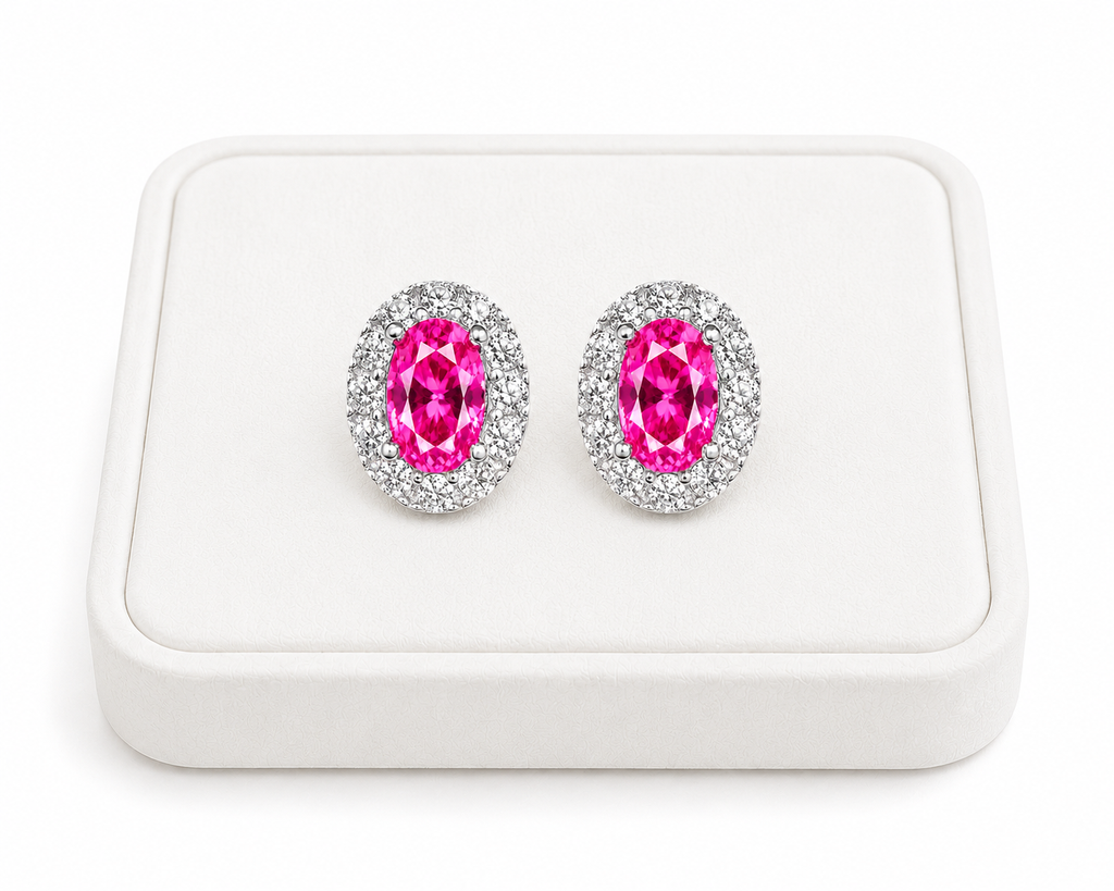 Pink topaz halo stud earrings displayed on a white jewelry tray with white background