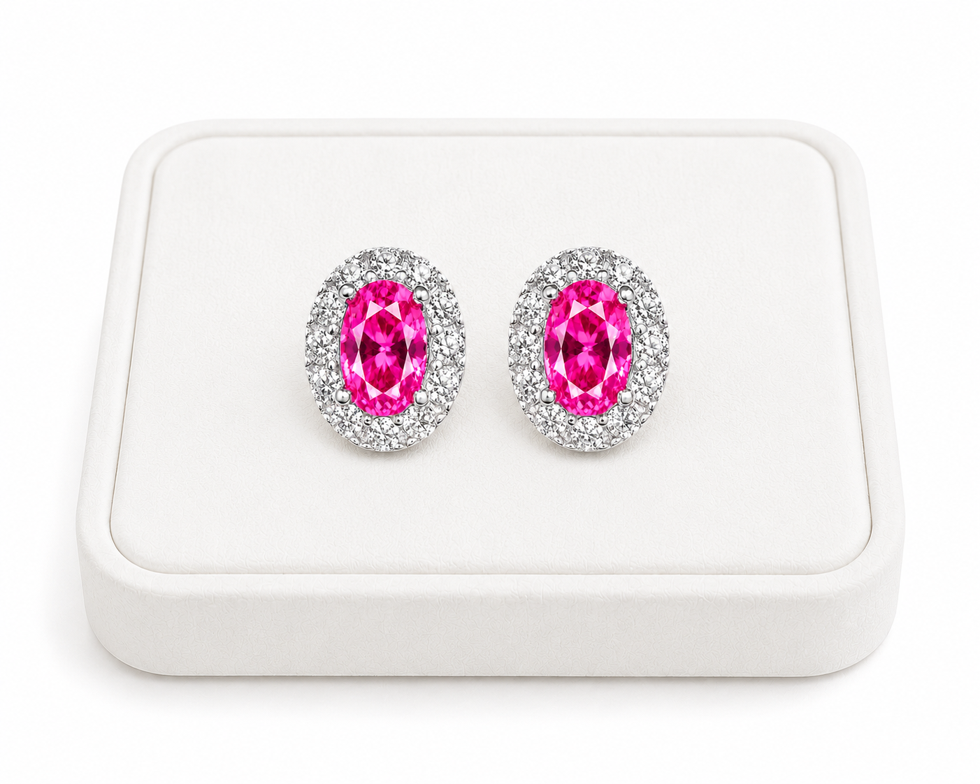Pink topaz halo stud earrings displayed on a white jewelry tray with white background