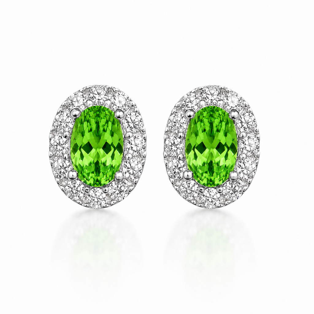 Natural green tsavorite stud earrings with 4x6mm oval gemstones and sparkling halo settings in sterling silver