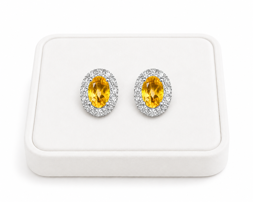 Natural citrine halo stud earrings displayed on luxury white jewelry tray