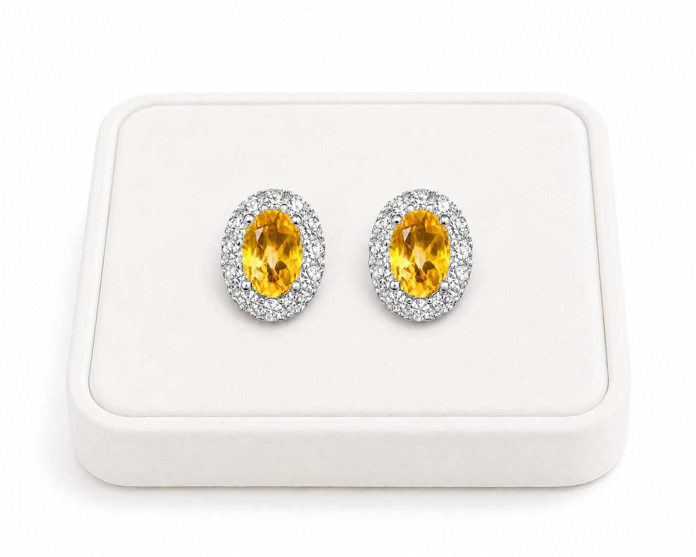 Natural citrine halo stud earrings displayed on luxury white jewelry tray