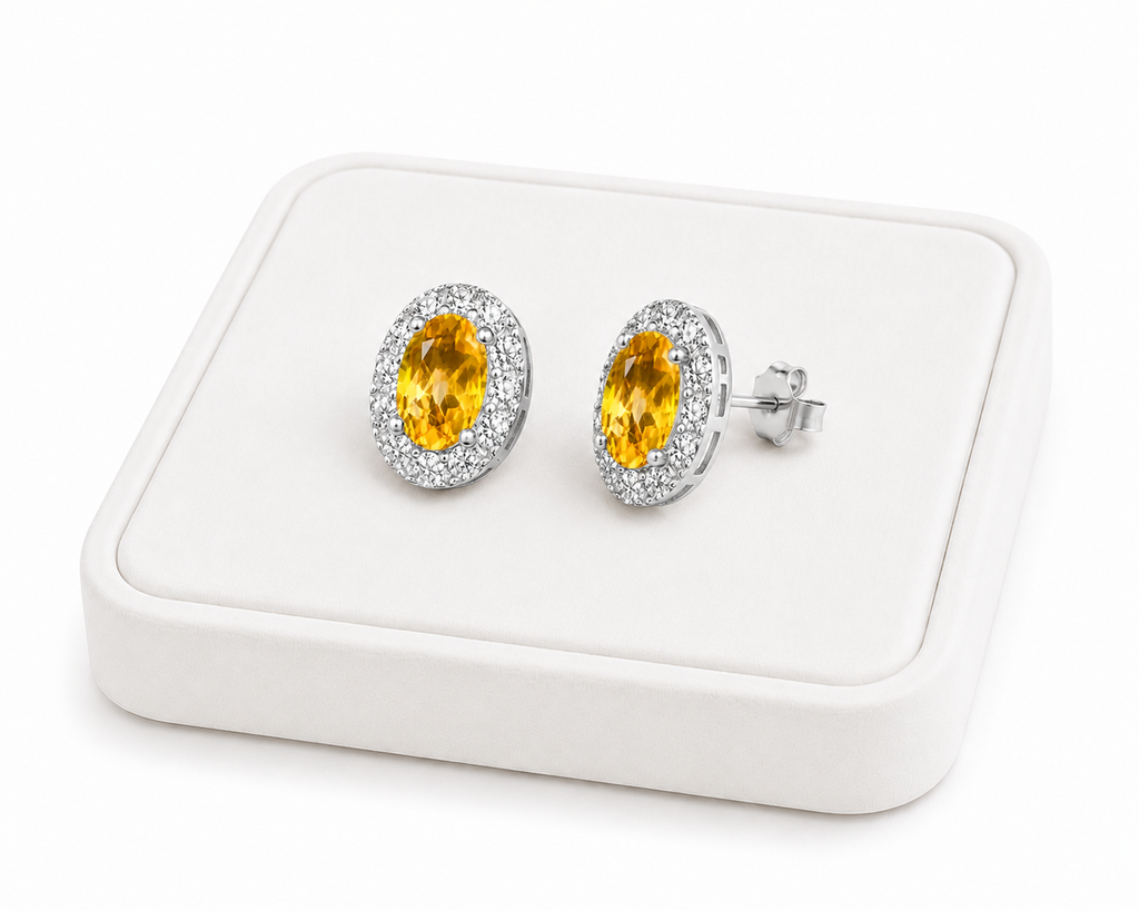 Natural citrine halo stud earrings displayed on luxury white jewelry tray