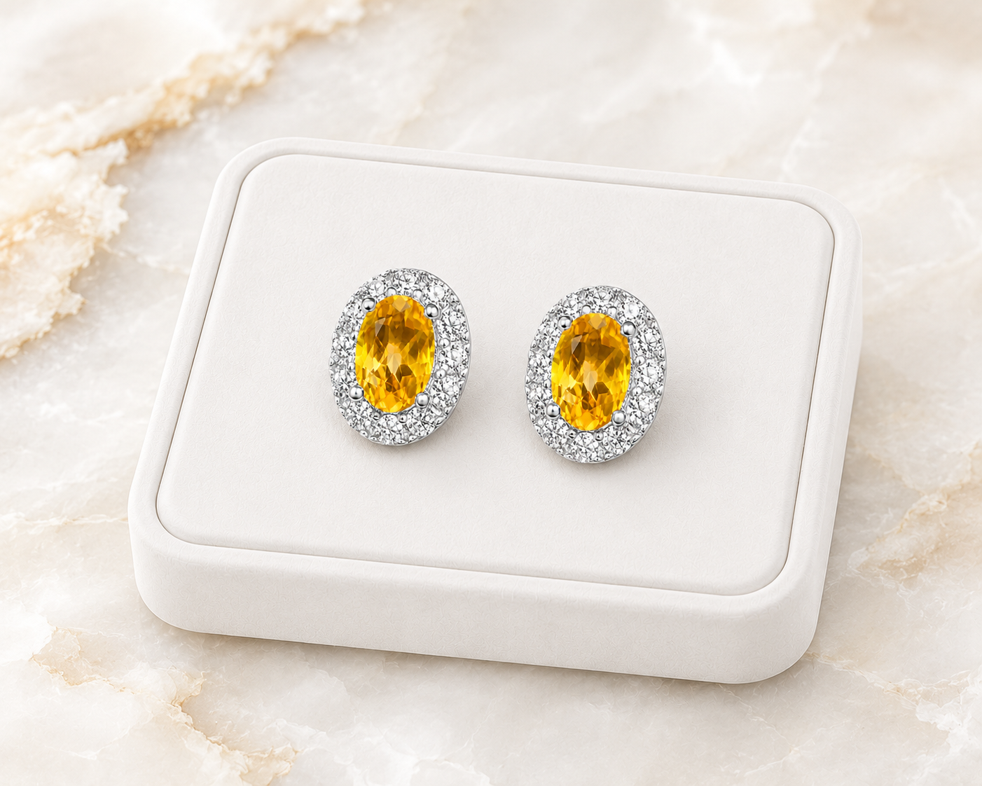 Natural citrine halo stud earrings displayed on luxury white jewelry tray