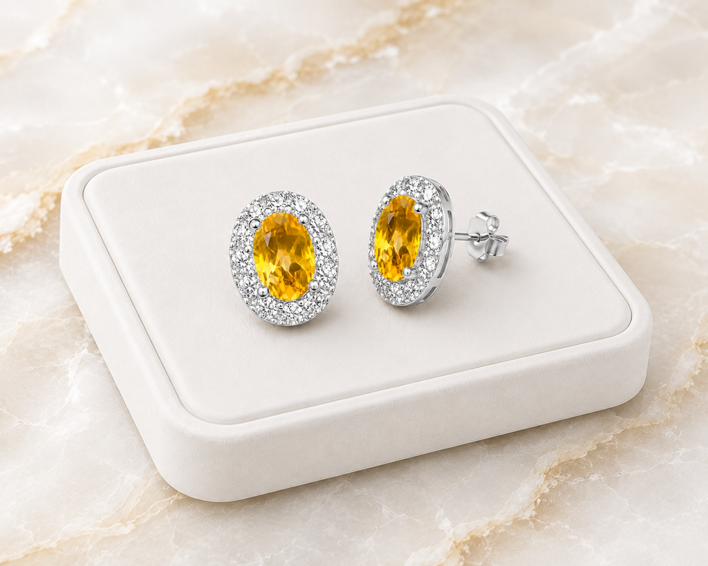 Natural citrine halo stud earrings displayed on luxury white jewelry tray