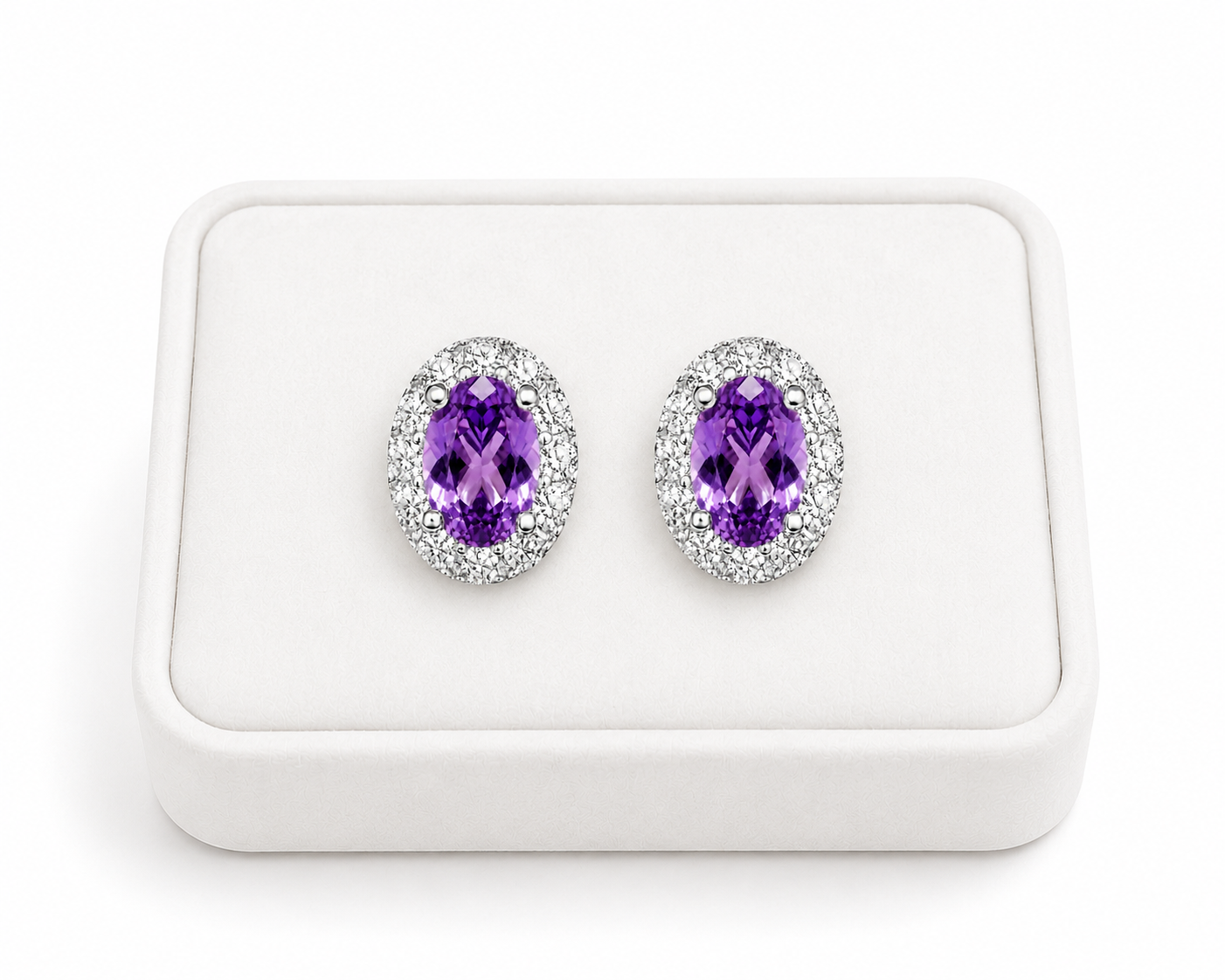 Natural 4x6mm amethyst halo earrings displayed on a luxury white jewelry tray