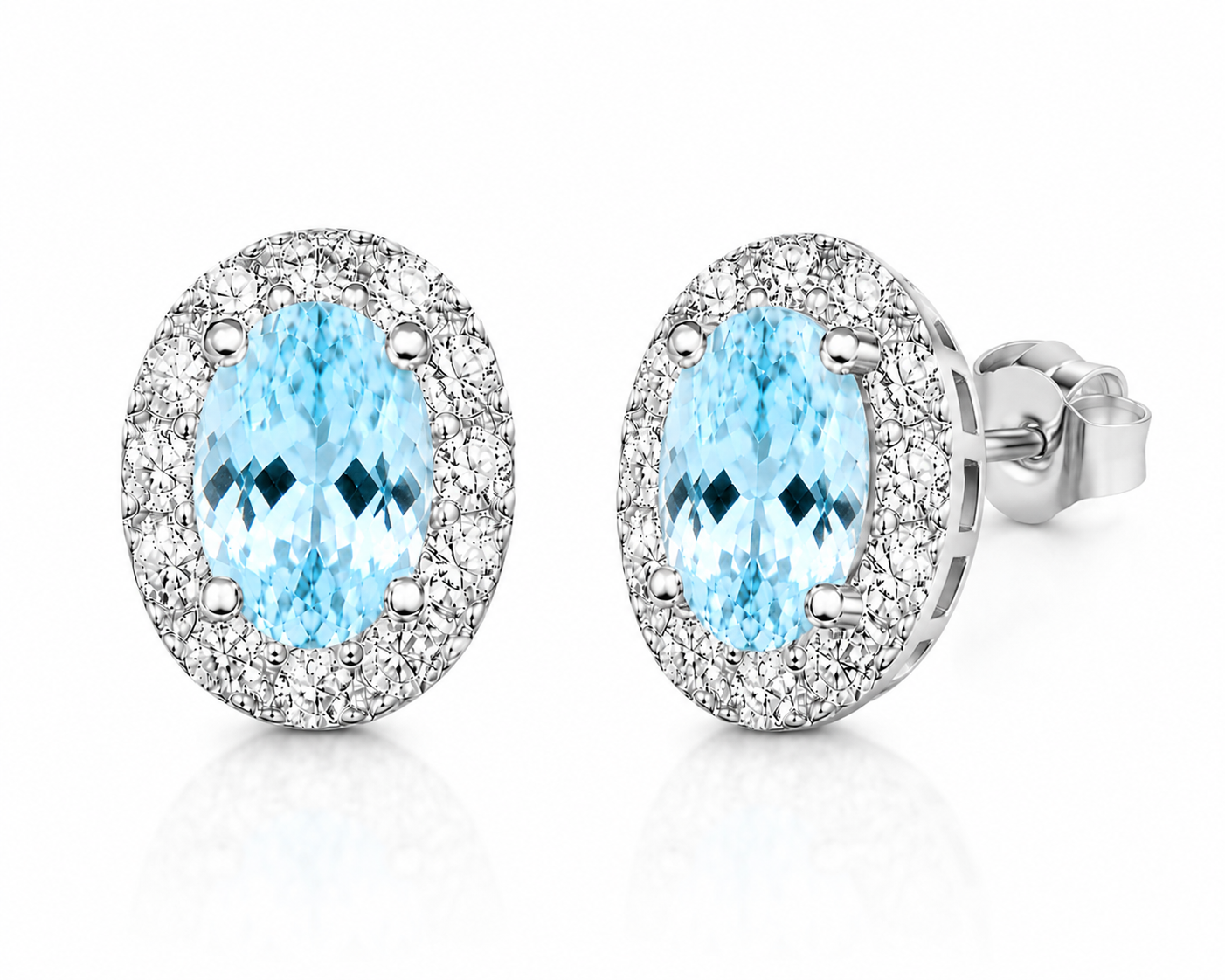 Macro close-up of natural aquamarine earrings showing blue gemstone facets and sparkling CZ halo