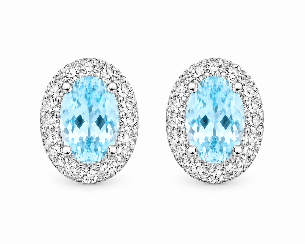 Top-down view of natural oval aquamarine halo stud earrings in sterling silver