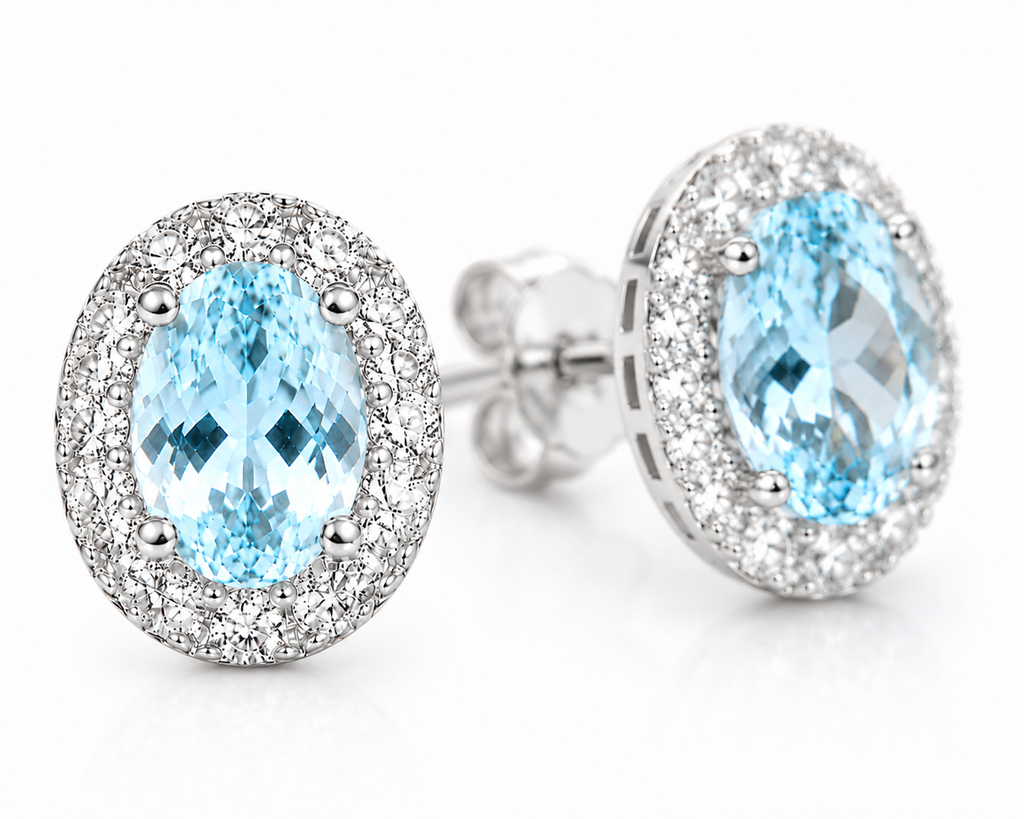 4x6mm natural aquamarine earrings shown at a three-quarter angle with sparkling halo accents