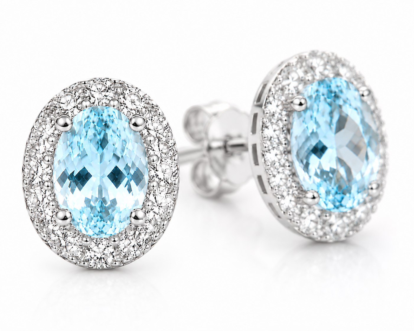 4x6mm natural aquamarine earrings shown at a three-quarter angle with sparkling halo accents