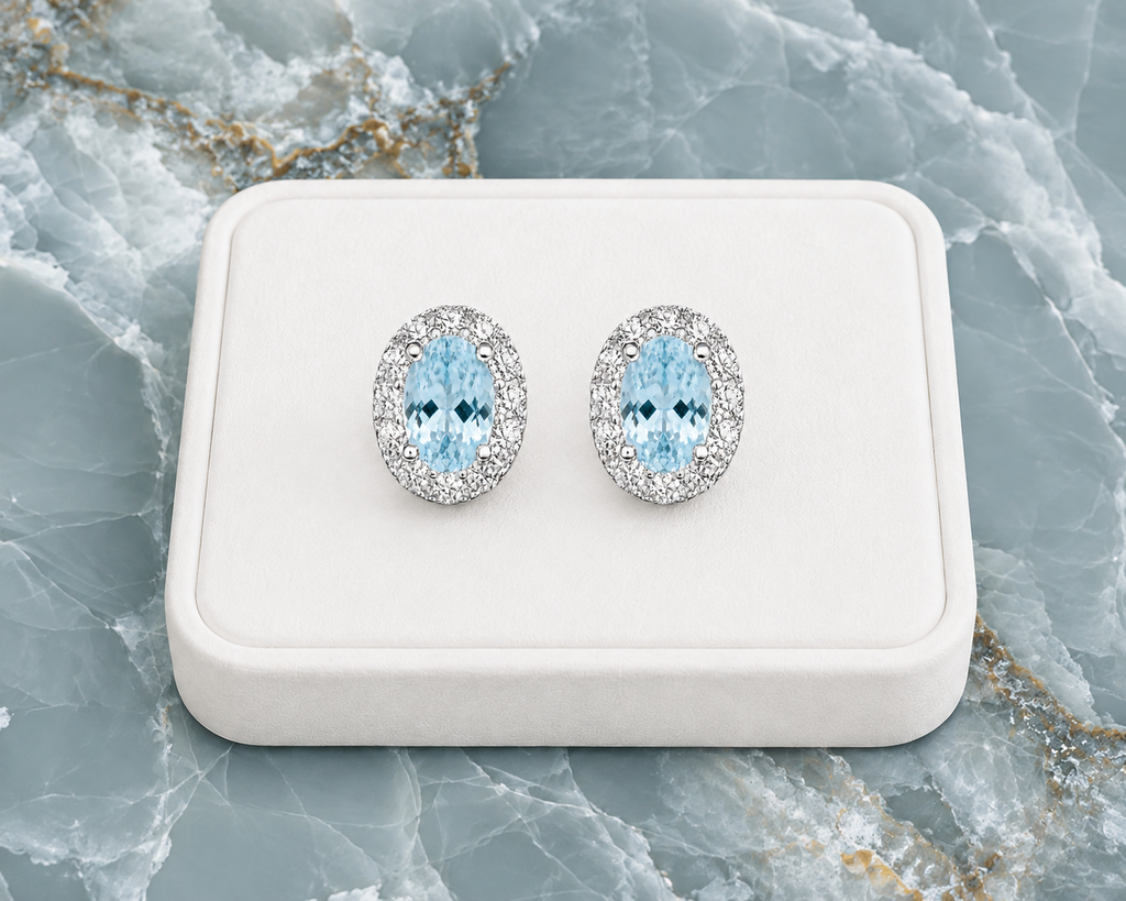 Natural 4x6mm aquamarine halo earrings displayed on a luxury jewelry tray