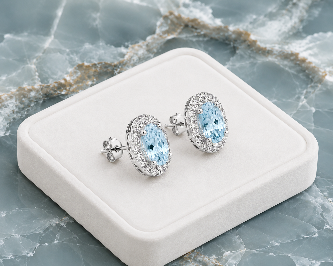Natural 4x6mm aquamarine halo earrings displayed on a luxury jewelry tray