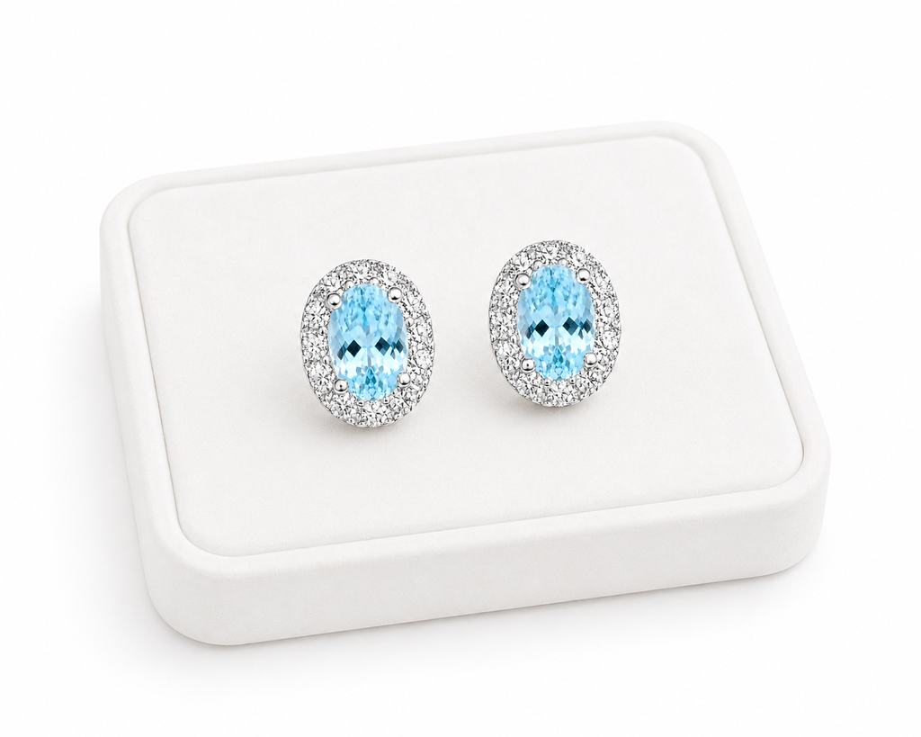 Natural 4x6mm aquamarine halo earrings displayed on a luxury jewelry tray