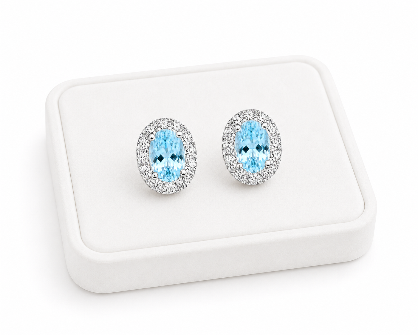 Natural 4x6mm aquamarine halo earrings displayed on a luxury jewelry tray