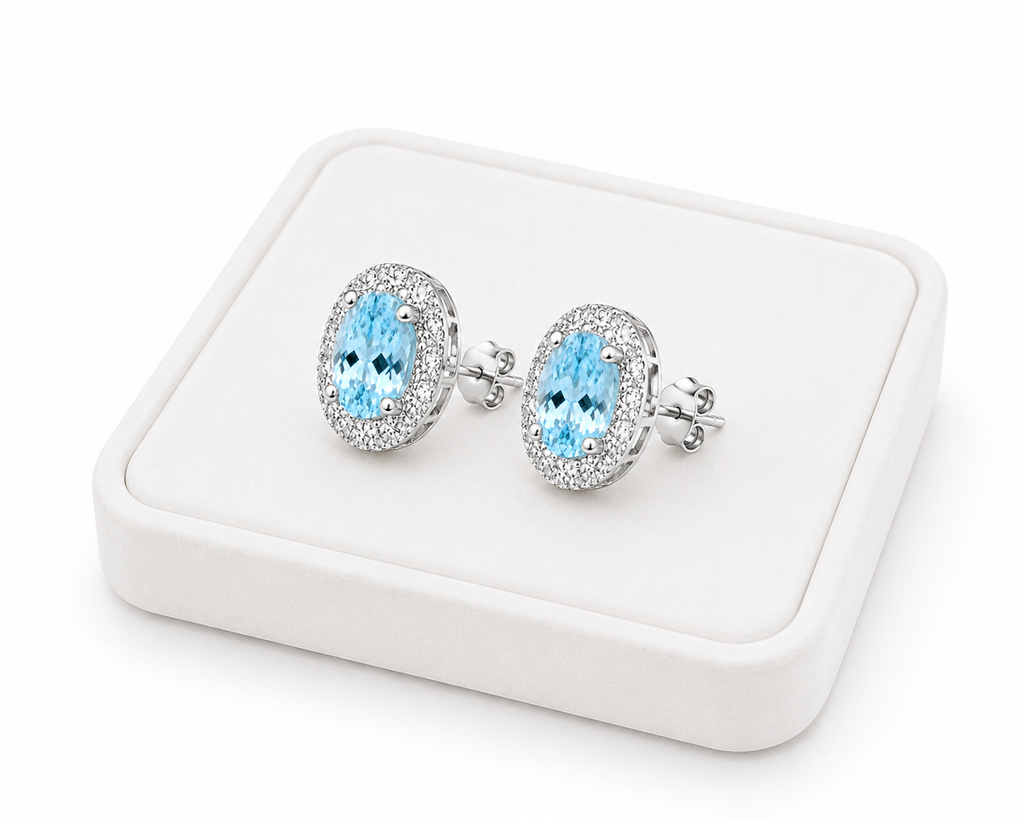 Natural 4x6mm aquamarine halo earrings displayed on a luxury jewelry tray