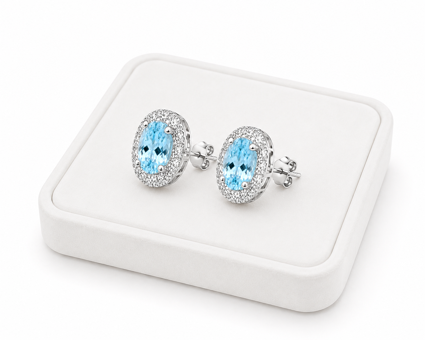 Natural 4x6mm aquamarine halo earrings displayed on a luxury jewelry tray