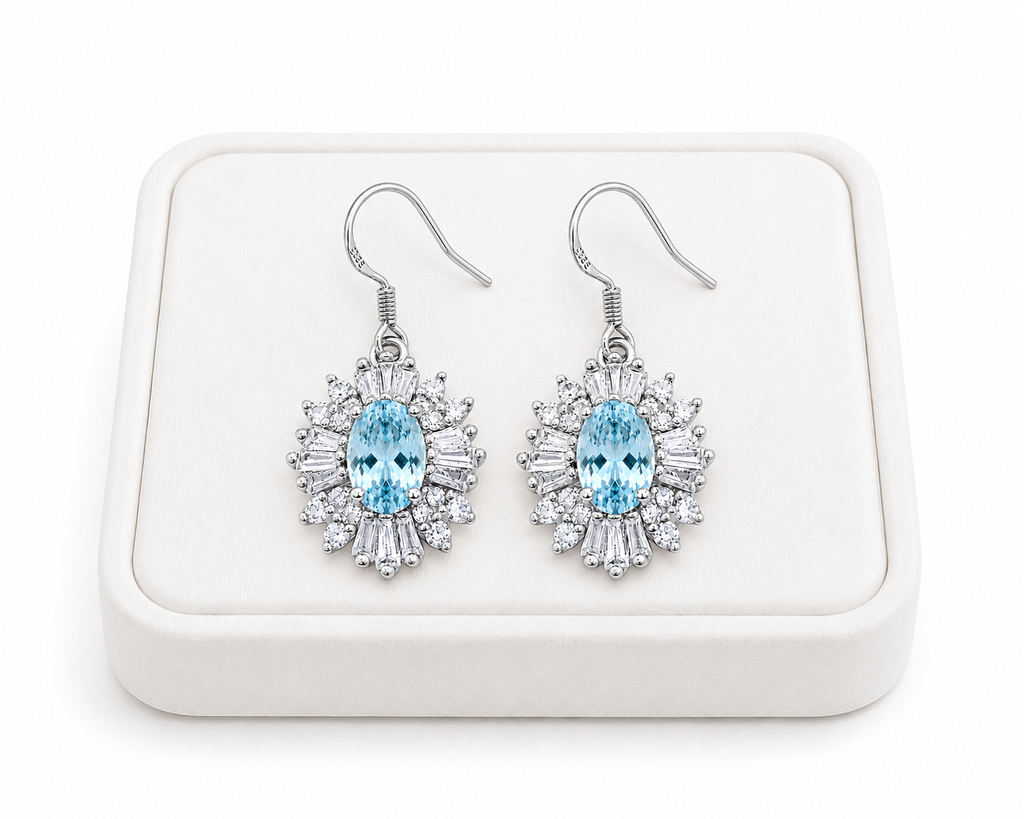 Natural aquamarine dangle earrings displayed on luxury white jewelry tray