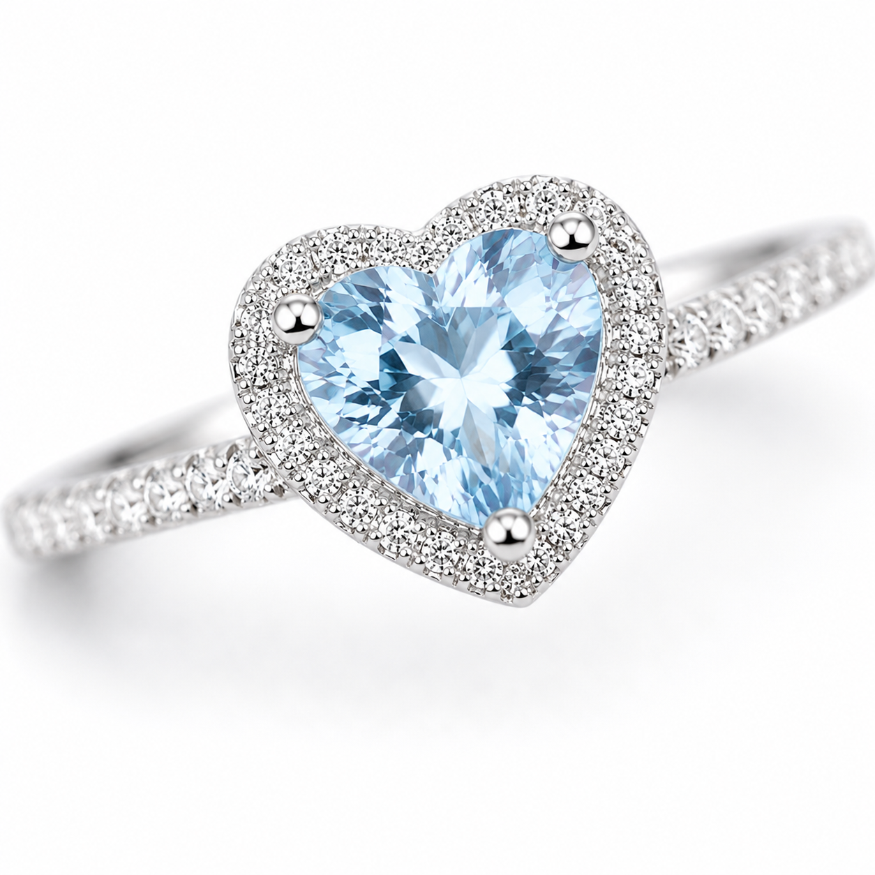 Macro close-up of natural 6mm heart-cut aquamarine gemstone and sparkling CZ halo