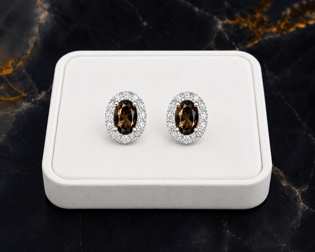 Natural smoky quartz stud earrings on luxury white jewelry tray with black marble background