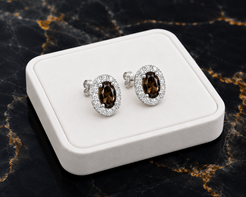 Natural smoky quartz stud earrings on luxury white jewelry tray with black marble background