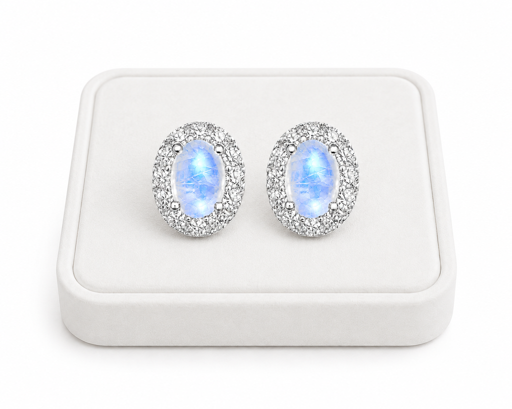 Natural 4x6mm Blue Moonstone halo earrings displayed on a white jewelry tray