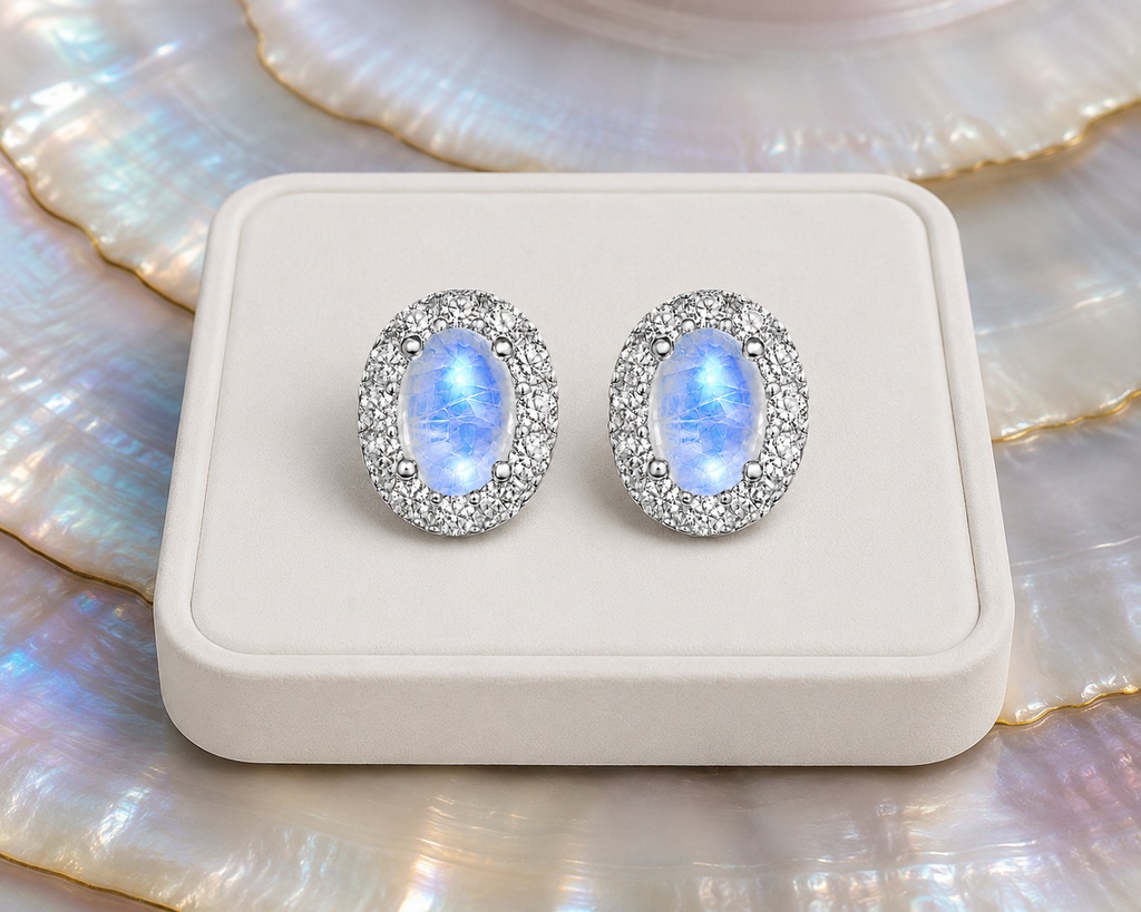 Blue Moonstone sterling silver halo earrings on luxury jewelry display