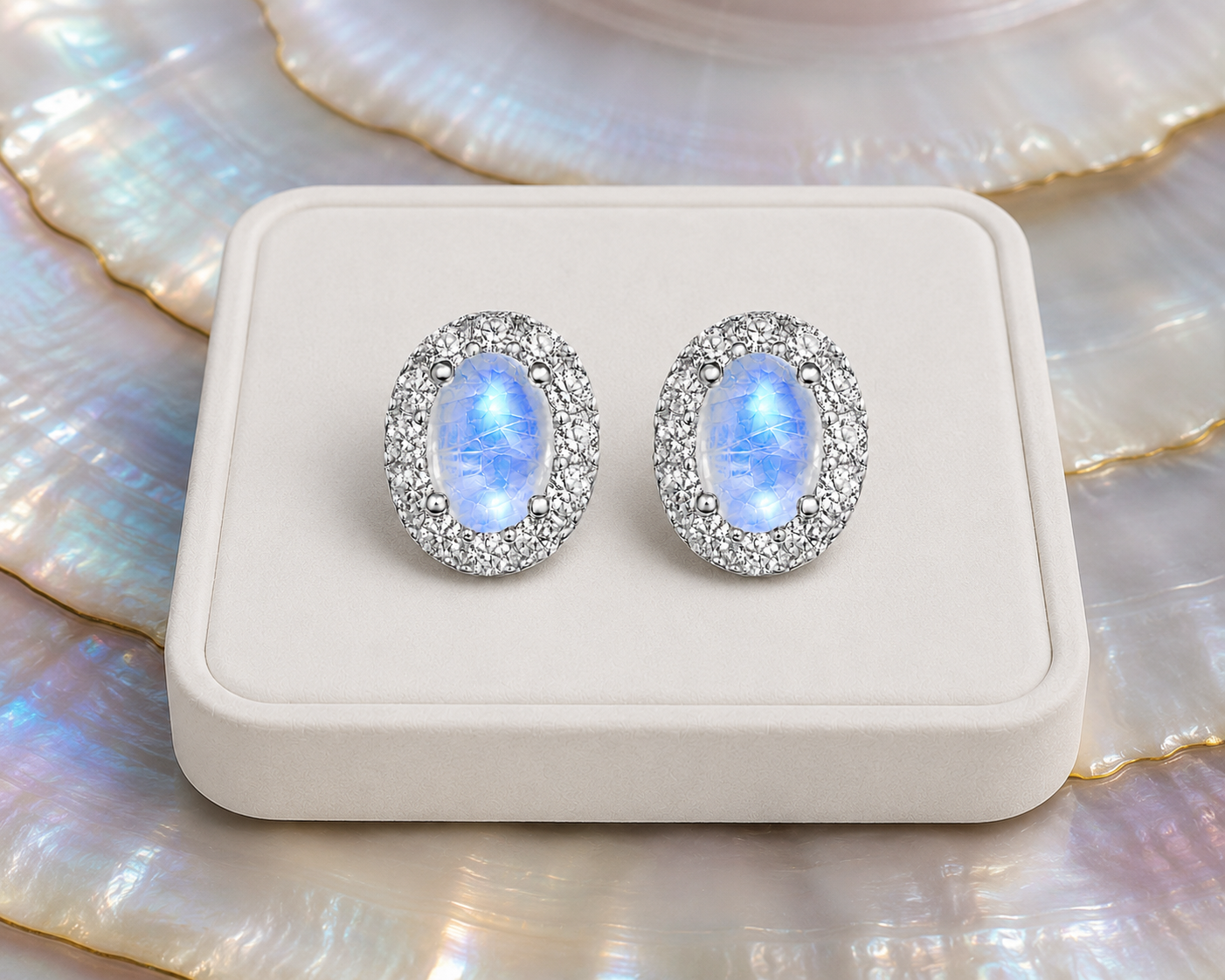 Blue Moonstone sterling silver halo earrings on luxury jewelry display
