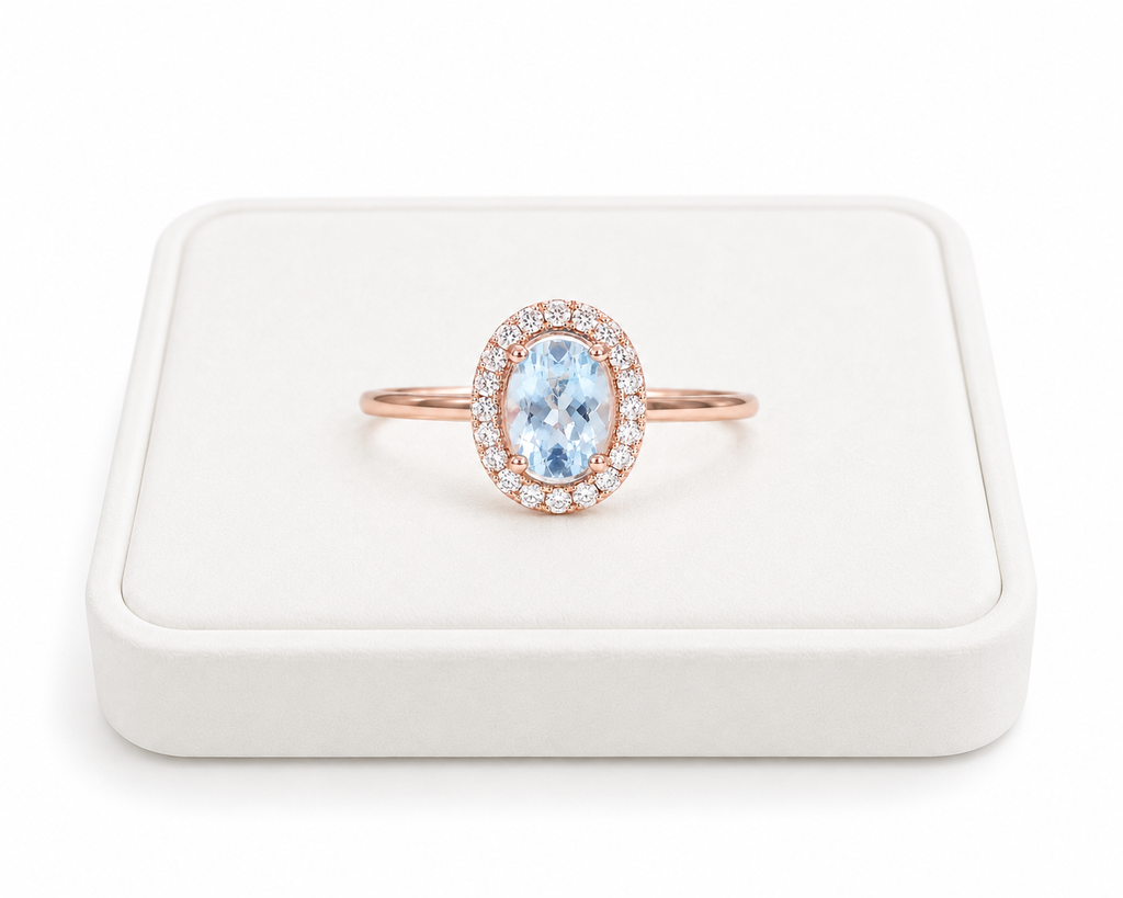 Natural 4x6mm oval aquamarine halo ring with cubic zirconia accents in sterling silver