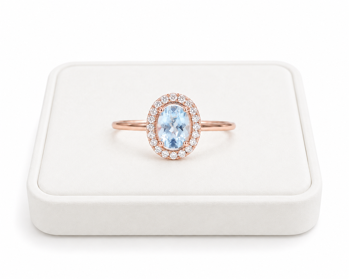 Natural 4x6mm oval aquamarine halo ring with cubic zirconia accents in sterling silver