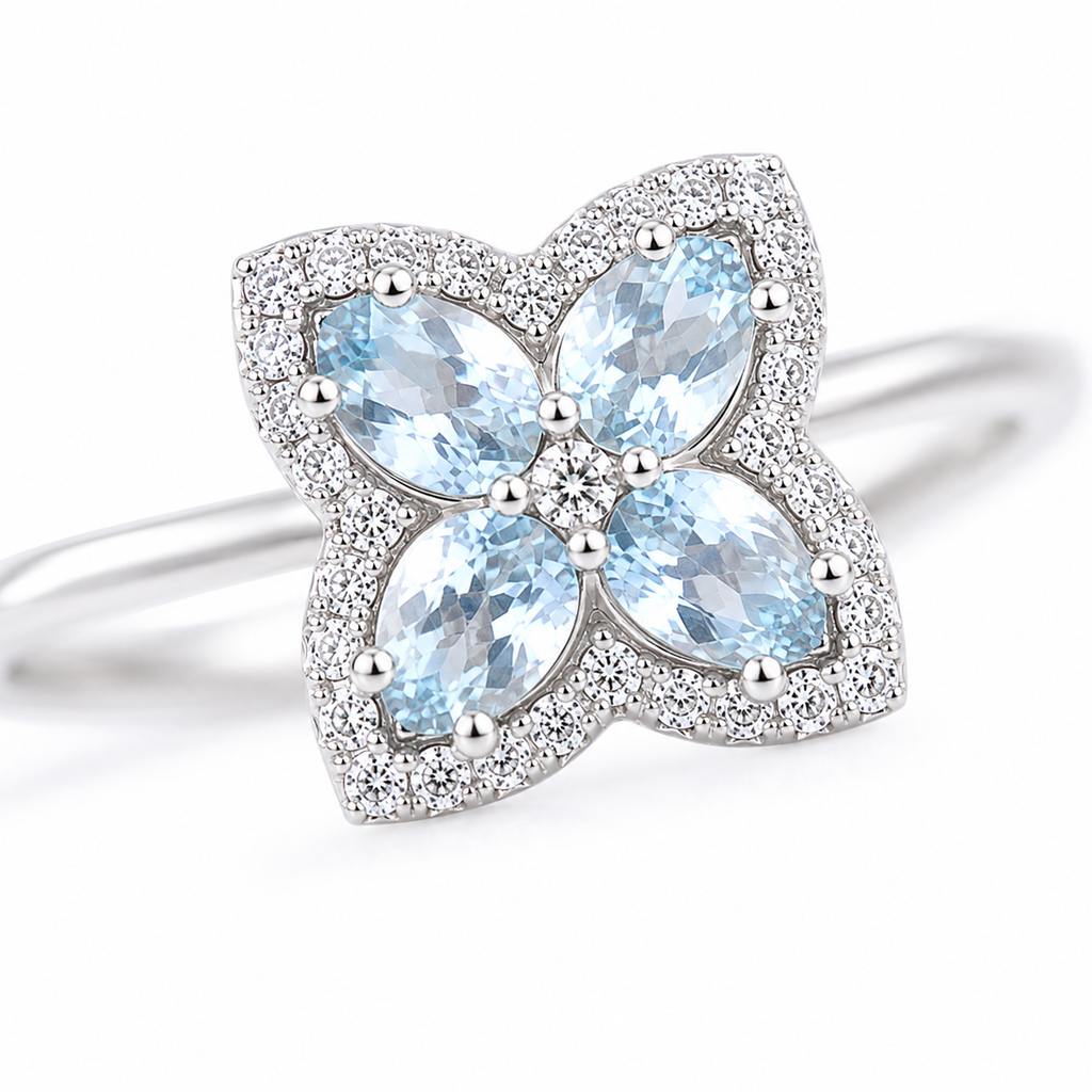 Macro close-up of natural aquamarine floral ring showing faceted blue gemstones and sparkling accents