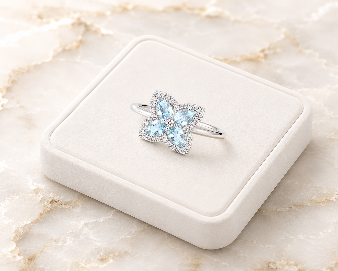 Natural aquamarine floral ring displayed on a white jewelry tray over luxury marble