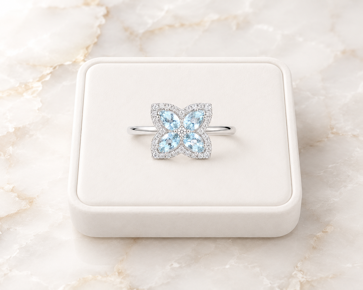 Natural aquamarine floral ring displayed on a white jewelry tray over luxury marble