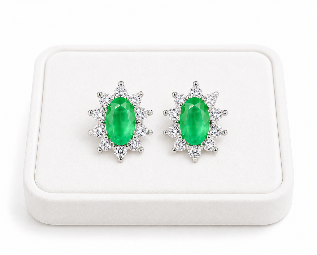 Natural emerald cluster stud earrings displayed on a luxury white jewelry tray